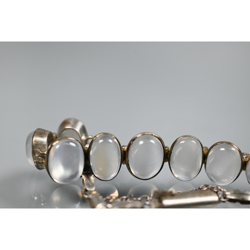 272 - A graduated moonstone and white metal bracelet, 16 cm long