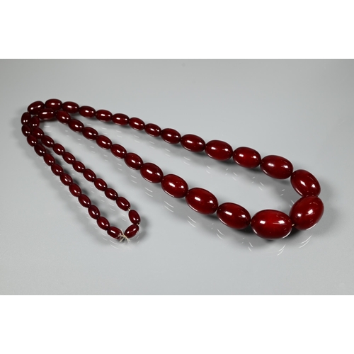 277 - Three rows of graduated amber beads including one cherry red, approx 183g (3)