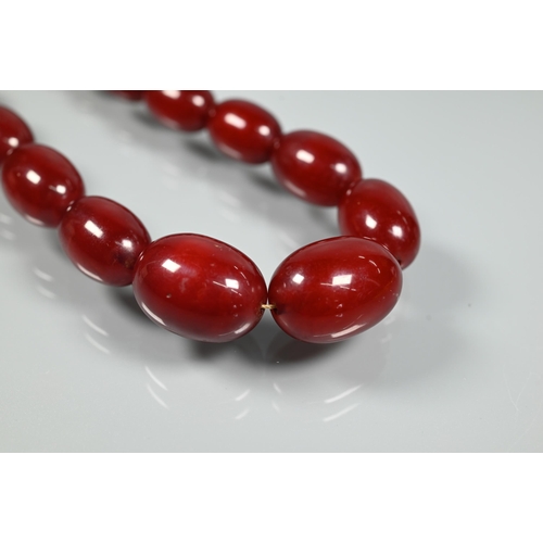 277 - Three rows of graduated amber beads including one cherry red, approx 183g (3)