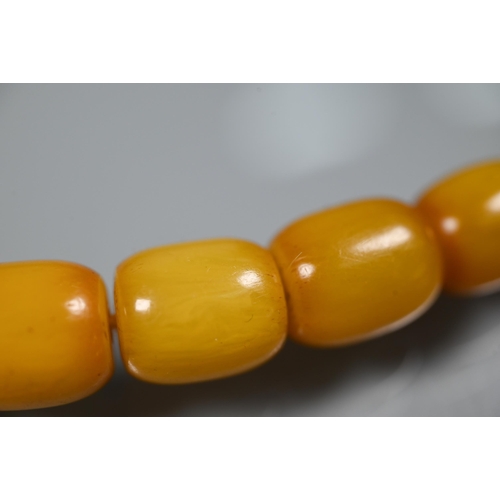 277 - Three rows of graduated amber beads including one cherry red, approx 183g (3)