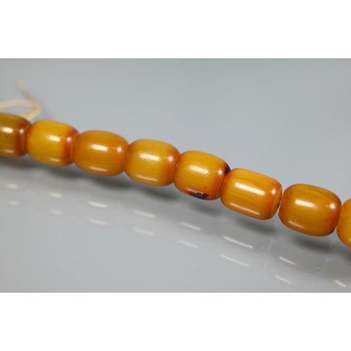 277 - Three rows of graduated amber beads including one cherry red, approx 183g (3)