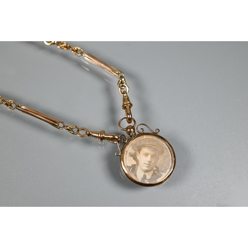 278 - A 9ct fancy link Albert chain with bar and two swivels suspending double-sided locket and with 1896 ... 