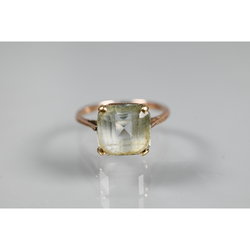 285 - A square pale aquamarine set unmarked yellow metal, size K, 0.6 x 0.6 cm