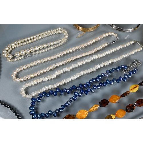 295 - Mixed jewellery including three bangles, five various simulted pearl necklaces, amber necklace, brac... 