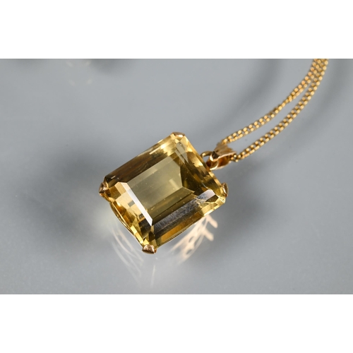 301 - A rectangular baguette-cut yellow topaz pendant on yellow metal chain, the topaz approx 1.3 x 1.1 cm