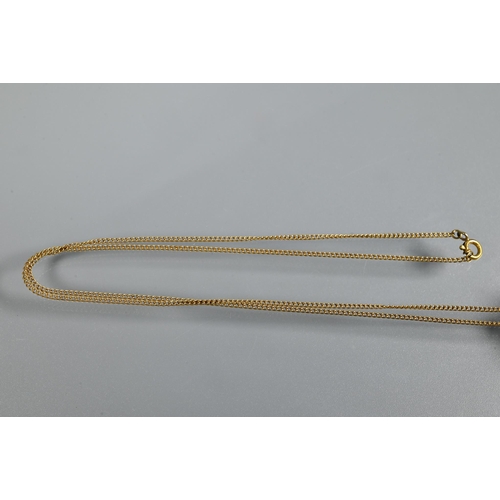 301 - A rectangular baguette-cut yellow topaz pendant on yellow metal chain, the topaz approx 1.3 x 1.1 cm