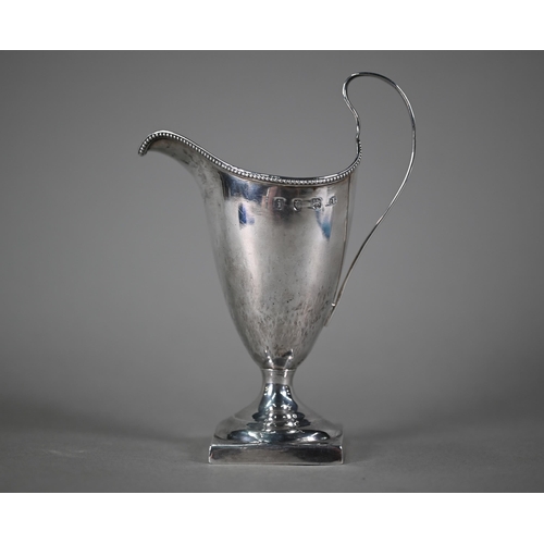 31 - A George III silver cream jug in the Adam style, with beaded rim and scroll handle, on stemmed squar... 