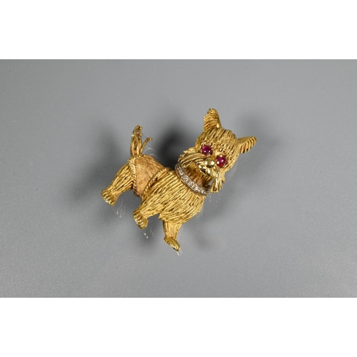 317 - A yellow metal brooch in the form of a standing dog, possibly a Yorkshire terrier, with diamond set ... 