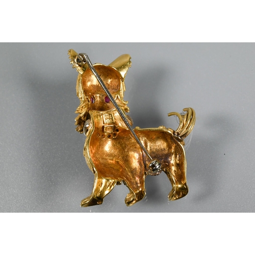 317 - A yellow metal brooch in the form of a standing dog, possibly a Yorkshire terrier, with diamond set ... 