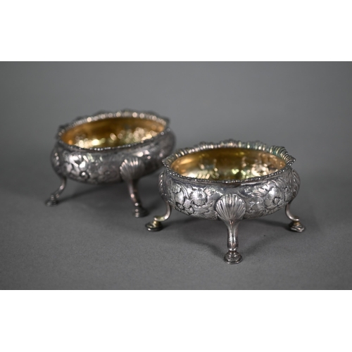 32 - A pair of George III silver oval salts with floral chased decoration and hoof feet (maker's mark rub... 