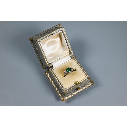 329 - An antique green stone and diamond ring, the central rectangular step cut stone in milgrain setting ... 