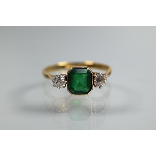 329 - An antique green stone and diamond ring, the central rectangular step cut stone in milgrain setting ... 