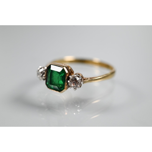 329 - An antique green stone and diamond ring, the central rectangular step cut stone in milgrain setting ... 