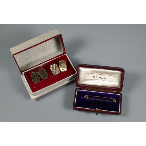 335 - A pair of 9ct yellow gold rectangular cufflinks with engine turned decoration and engraved initials,... 