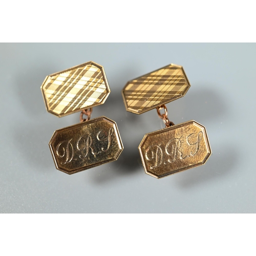 335 - A pair of 9ct yellow gold rectangular cufflinks with engine turned decoration and engraved initials,... 