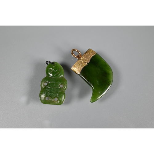 338 - A green nephrite carved tiki, 3 cm long and a green nephrite claw with engraved yellow metal mount t... 