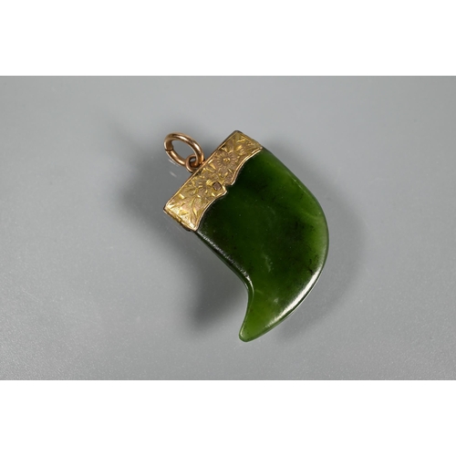 338 - A green nephrite carved tiki, 3 cm long and a green nephrite claw with engraved yellow metal mount t... 