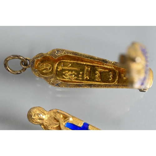 339 - A propelling pencil in the form of a gilt metal and enamel sarcophagus, 3 cm long; a smaller sarcoph... 