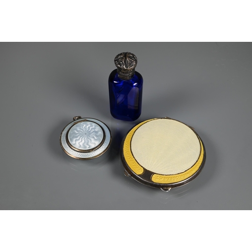 341 - An Art Deco silver and yellow enamel powder compact, Birmingham 1920, 7 cm diam; a locket silver and... 