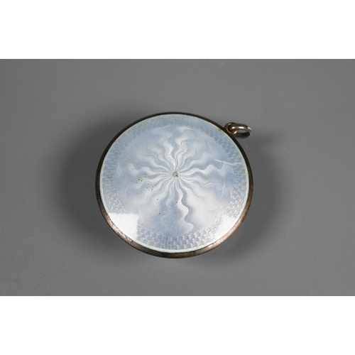 341 - An Art Deco silver and yellow enamel powder compact, Birmingham 1920, 7 cm diam; a locket silver and... 