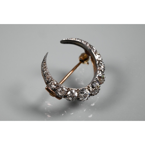 345 - An antique diamond-set crescent brooch, the graduated old brilliant cut diamonds in silver and rose ... 