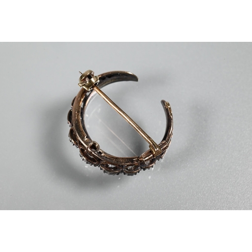 345 - An antique diamond-set crescent brooch, the graduated old brilliant cut diamonds in silver and rose ... 