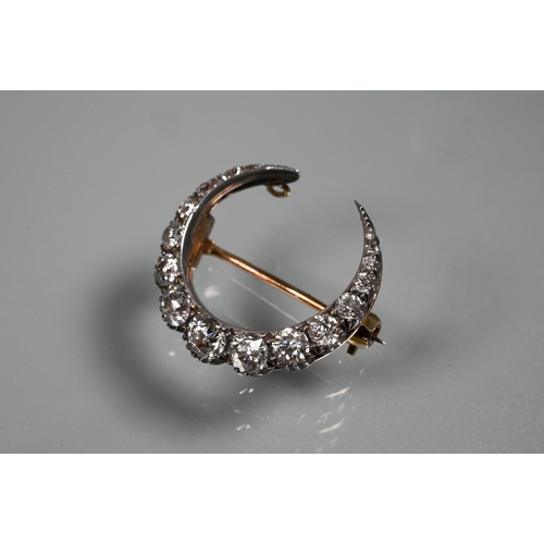 345 - An antique diamond-set crescent brooch, the graduated old brilliant cut diamonds in silver and rose ... 