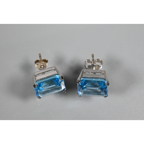 346 - A suite comprising rectangular emerald-cut blue topaz pendant and matching earrings for pierced ears... 