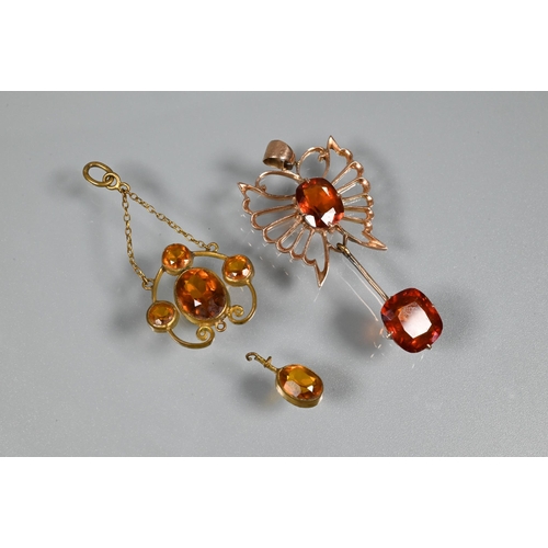 355 - A pendant in the form of a butterfly with open wings, set dark orange stones, possibly fire opals; a... 