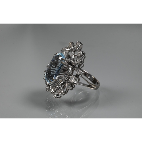 358 - A contemporary statement cluster ring, the oval claw set aquamarine surrounded by an arrangement of ... 