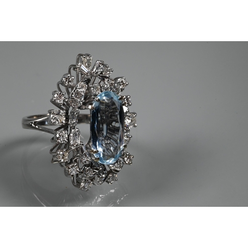 358 - A contemporary statement cluster ring, the oval claw set aquamarine surrounded by an arrangement of ... 