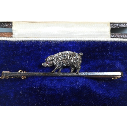 361 - A late 19th century bar brooch with diamond-set pig, the pig pave set with rose cut diamonds and cab... 