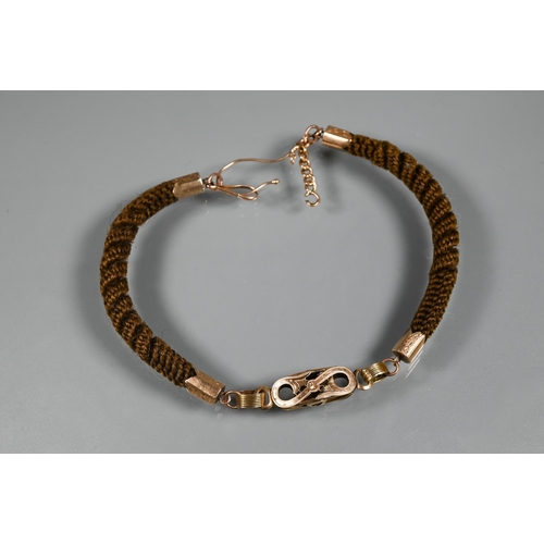 372 - A Victorian mourning bracelet of intricately plaited hairwork, with gold mounts and links