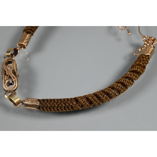 372 - A Victorian mourning bracelet of intricately plaited hairwork, with gold mounts and links