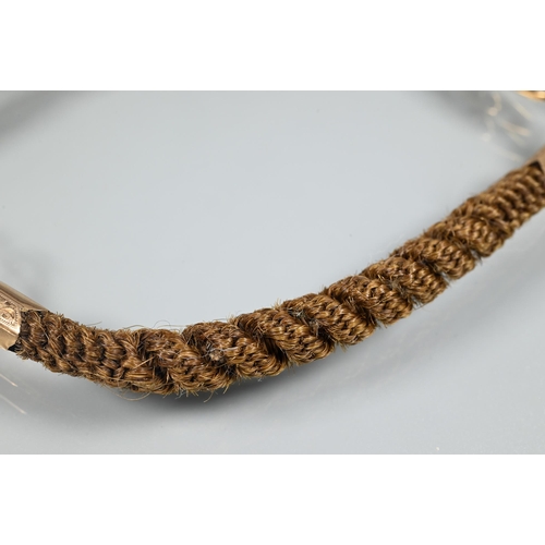 372 - A Victorian mourning bracelet of intricately plaited hairwork, with gold mounts and links