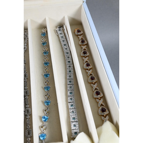 378 - A collection of various simulated gem-set bracelets, mostly stamped 925, in fitted jewel box