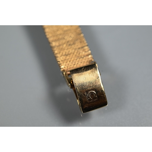 403 - An Omega 9ct gold ladies wristwatch, the 14 mm square case with gilt dial and textured strap (26 g a... 