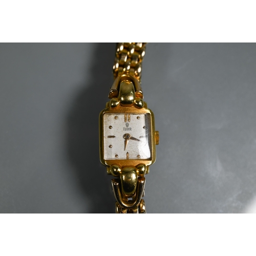 404 - A Tudor 14k ladies wrist watch, the 15 mm case with champagne dial, 28.8g all-in (no box/documents) ... 