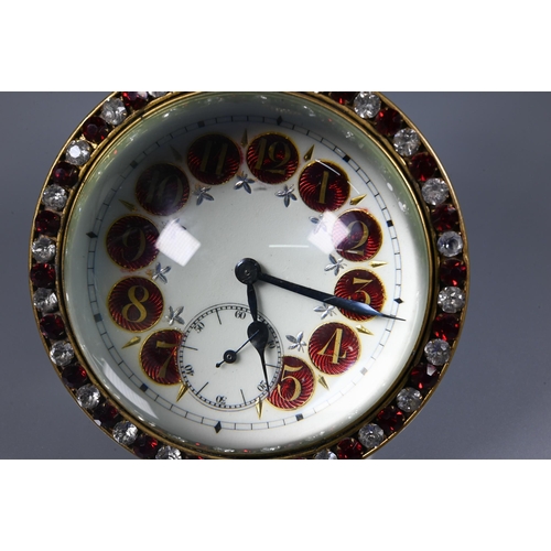 424 - A Victorian style goliath ball desk clock, the white dial with part enamelled Arabic hour markers, a... 