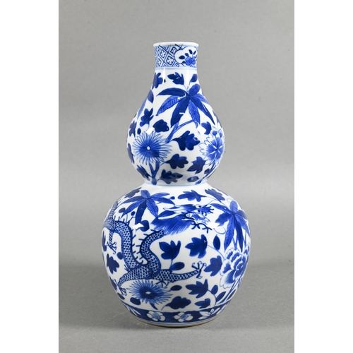 431 - A 19th/20th century Chinese blue and white double gourd vase painted with two sinuous dragons amongs... 