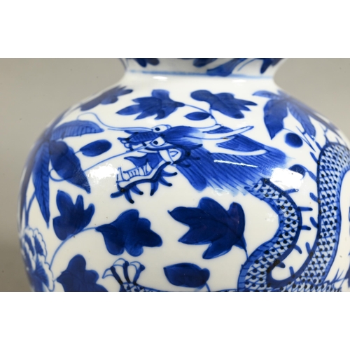 431 - A 19th/20th century Chinese blue and white double gourd vase painted with two sinuous dragons amongs... 