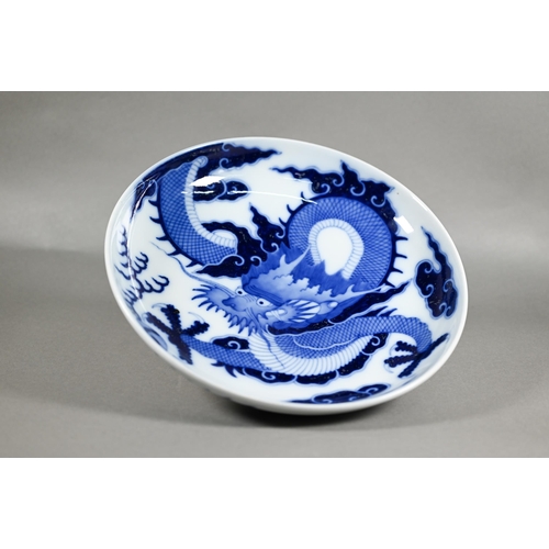 457 - A Chinese transitional style blue and white dragon charger in the mid 17th century manner, painted i... 