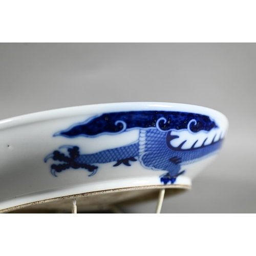 457 - A Chinese transitional style blue and white dragon charger in the mid 17th century manner, painted i... 