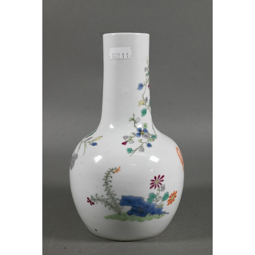 462 - A 19th century Chinese famille rose bottle vase, painted in polychrome enamels with a tall prunus tr... 