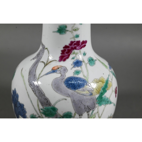 462 - A 19th century Chinese famille rose bottle vase, painted in polychrome enamels with a tall prunus tr... 