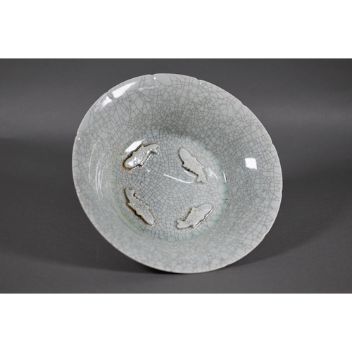 463 - A Chinese lonquan Celadon floriform bowl with four relief moulded fish and pale green crackled glaze... 