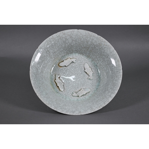 463 - A Chinese lonquan Celadon floriform bowl with four relief moulded fish and pale green crackled glaze... 