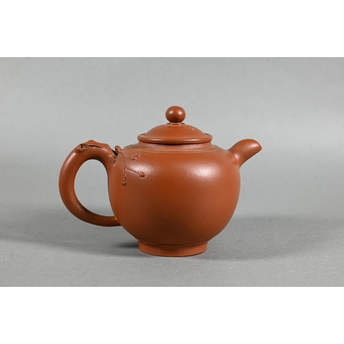 466 - A vintage Chinese Yixing teapot and cover with relief moulded prunus decoration, circa 1970, seal ma... 