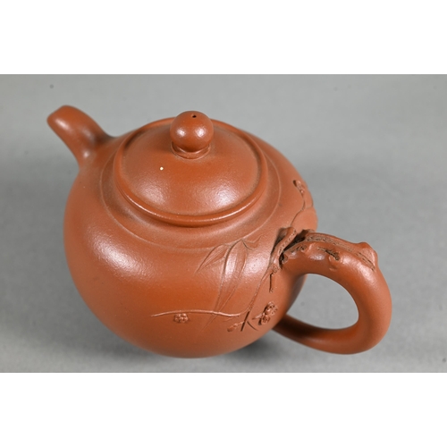 466 - A vintage Chinese Yixing teapot and cover with relief moulded prunus decoration, circa 1970, seal ma... 