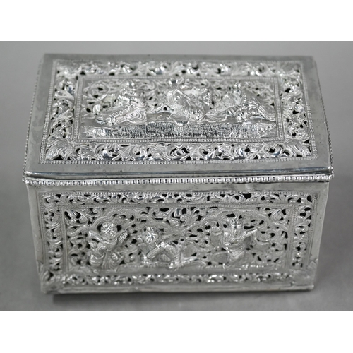 47 - A late 19th/early 20th century Burmese pierced silver (unmarked) box with hinged cover, richly embos... 